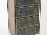 a small chest of drawers that has three drawers on it