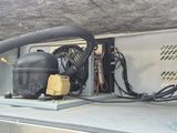 a small air conditioner sitting on top of a truck