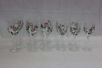 six verres à vin sont alignés sur une surface blanche