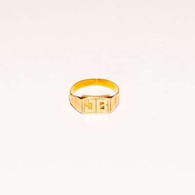 an image of a gold ring with a greek design on it