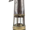 an old fashioned metal lantern with a light on top of it
