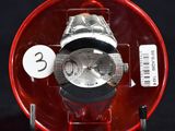 a watch in a red case on a black background