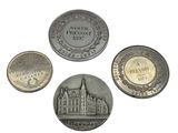 four different types of coins are shown on a white surface