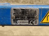 a close up of a sign on the side of a blue pipe