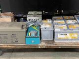 many boxes of batteries on a cart in the garage