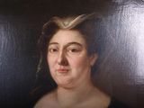 portrait of a woman in a black dress with her hair in a bun