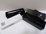 a black box with a pair of scissors inside of it