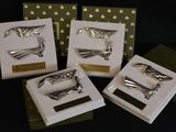 four different types of hair clips on display in a display case
