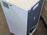 a white refrigerator that is sitting in a warehouse