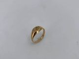 a close up of a gold ring on a white surface