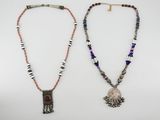 two necklaces, one with a pendant and the other with beads