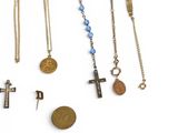 several different types of necklaces and charms on a white surface