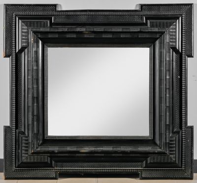 un miroir à cadre noir, composé d'un cadre en bois et d'un cadre métallique