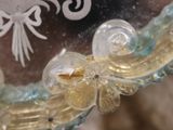 a close up of a glass clock with a bird on it ' s face