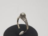 an image of a diamond ring on a black stand