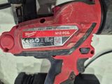 a close up of a red cordless drill with a black handle