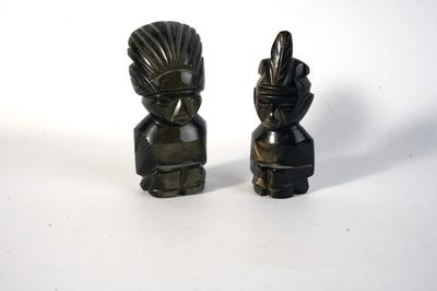two figurines that are sitting next to each other