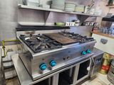 a large stove in a kitchen with many plates on it