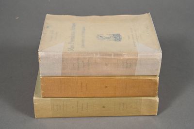 three books stacked on top of each other on a table