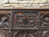 a wooden chest with carvings on it and a keyhole