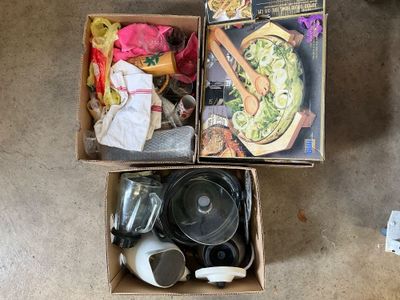 two boxes that have various items in them on the floor