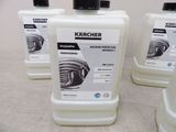 four bottles of karchher machine protectors are lined up on a table