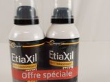two bottles of extrail on a white surface with a white background