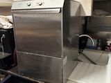 stainless steel dishwasher sitting on top of a counter in a kitchen