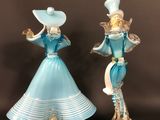 pair of blue glass figurines of a woman and a man