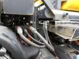 a close up of a truck engine with a hose attached to it