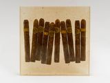 a close up of a box of cigars on a white surface
