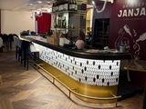 an image of a restaurant with a bar and chairs