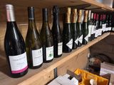 bottles of wine are lined up on a shelf in a wine shop