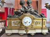 a statue of two children sitting on top of a clock