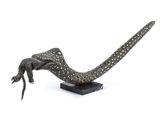 a statue of a lizard that is sitting on a table