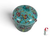 a blue box with flowers on it on a white surface