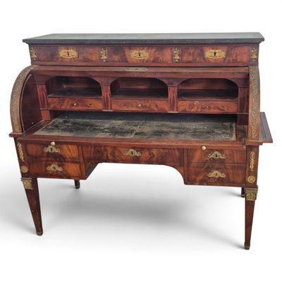 an antique writing desk with a marble top and drawers