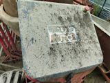 a cement block sitting on top of a pile of junk