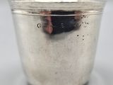 a silver cup that is sitting on a table