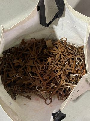 a white bag filled with lots of scissors on a table