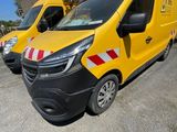 two yellow vans parked in a parking lot next to each other