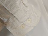 a teddy bear that is wearing a white shirt