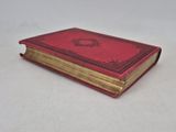 a red book sitting on top of a white table