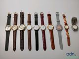 a lot of watches that are lined up on the table