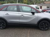 the silver car is parked in the parking lot near other cars
