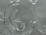 several empty wine glasses sitting on top of a white table