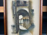 framed watercolor painting of a street scene with a bridge in the background