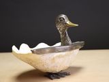 a bird that is sitting in a bowl on a table