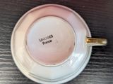 a cup with a saucer on a wooden table