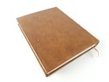 a brown leather notebook with a red string on the cover